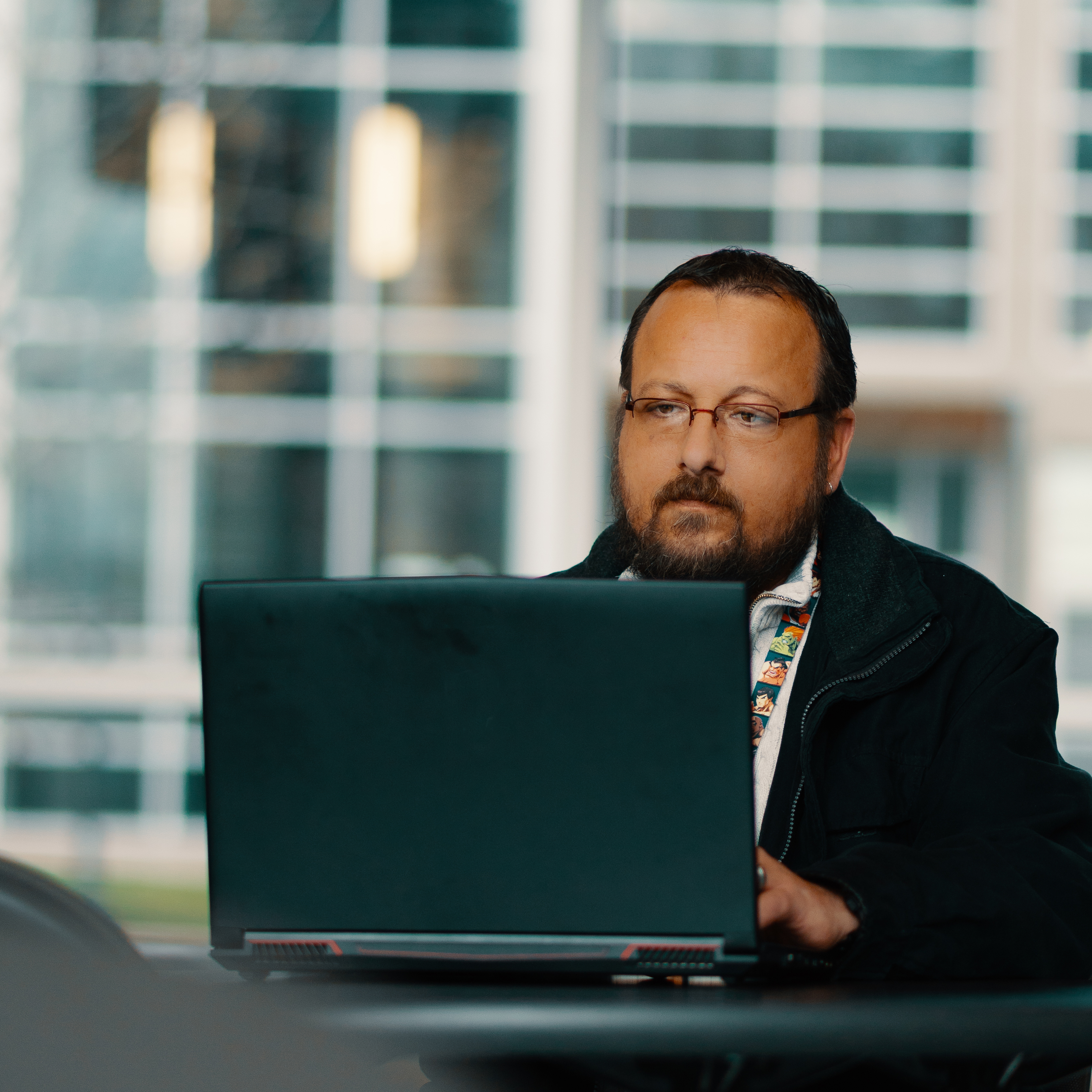 A male students works on a laptop in Washington Hall