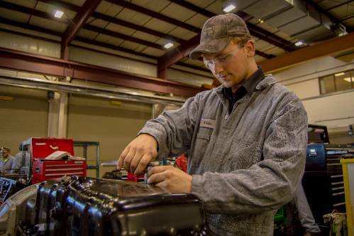 A diesel tech student in the diesel shop
