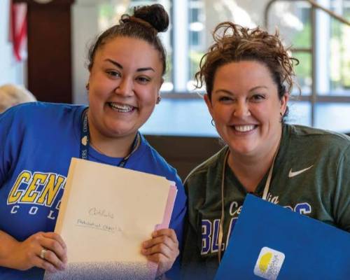Two Centralia College staffers smile at a 2024 outreach event on campus