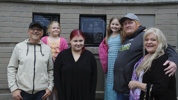 Rikkey's family poses with her new plaque on the Diversity Plaza